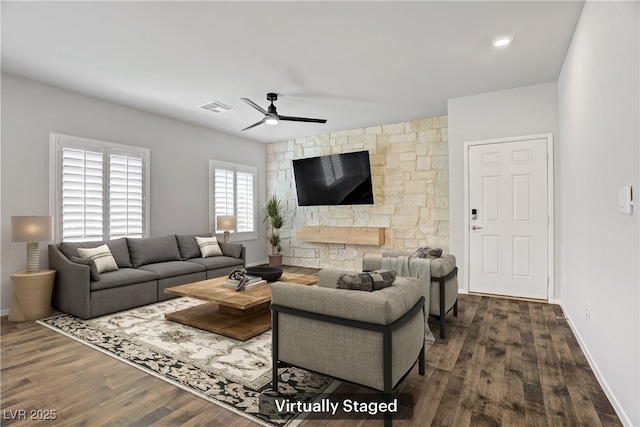 7546 Cooks Meadow St, North Las Vegas, NV 89084 - living room featuring a ceiling fan, dark wood finished floors, and a stone fireplace