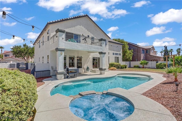229 Wellspring Ave, Las Vegas, NV 89183 - back of house with a balcony, a pool with connected hot tub, a patio area, a fenced backyard, and stucco siding