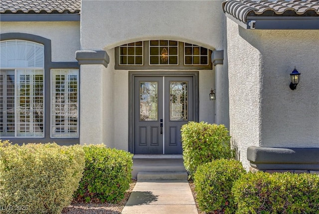 229 Wellspring Ave, Las Vegas, NV 89183 - view of exterior entry featuring stucco siding and a tile roof