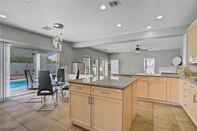 229 Wellspring Ave, Las Vegas, NV 89183 - kitchen with light tile patterned floors, light brown cabinets, ceiling fan, a center island, and recessed lighting