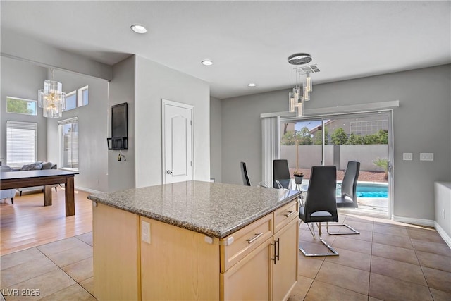 229 Wellspring Ave, Las Vegas, NV 89183 - kitchen with a chandelier, light tile patterned floors, stone countertops, plenty of natural light, and recessed lighting