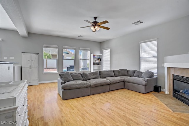 229 Wellspring Ave, Las Vegas, NV 89183 - living area with ceiling fan, light wood-style flooring, and a tile fireplace