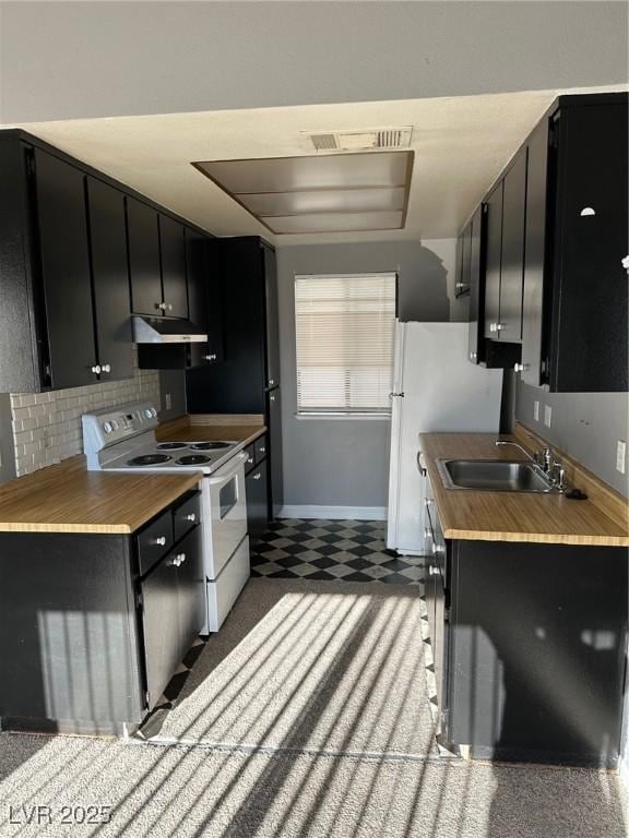 4241 Gannet Cir Unit 202, Las Vegas, NV 89103 - kitchen with white range with electric cooktop, dark cabinetry, backsplash, and tile patterned floors