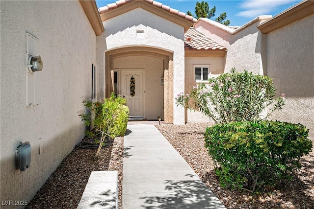 2441 Banora Point Dr, Las Vegas, NV 89134 - view of exterior entry with a tiled roof and stucco siding
