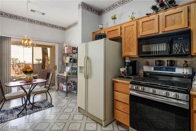 2441 Banora Point Dr, Las Vegas, NV 89134 - kitchen with stainless steel gas range oven, white refrigerator with ice dispenser, black microwave, a chandelier, and decorative light fixtures