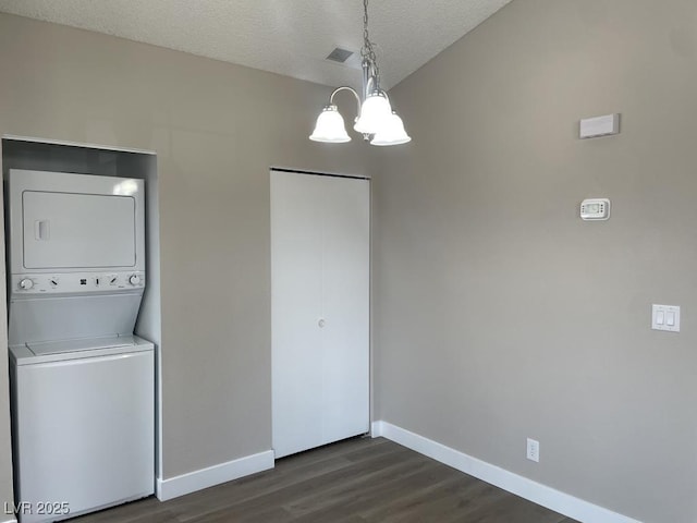 5385 Shake Ct Unit 203, Las Vegas, NV 89122 - laundry area featuring stacked washing machine and dryer, a chandelier, dark wood-type flooring, and a textured ceiling