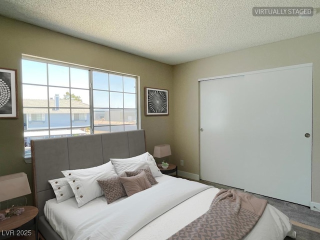5385 Shake Ct Unit 203, Las Vegas, NV 89122 - bedroom with a textured ceiling, a closet, and carpet floors