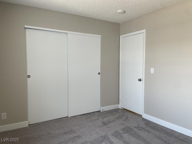 5385 Shake Ct Unit 203, Las Vegas, NV 89122 - unfurnished bedroom with a closet, carpet flooring, and a textured ceiling
