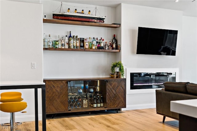 3890 Quadrel St, Las Vegas, NV 89129 - indoor dry bar with wood finished floors and a glass covered fireplace
