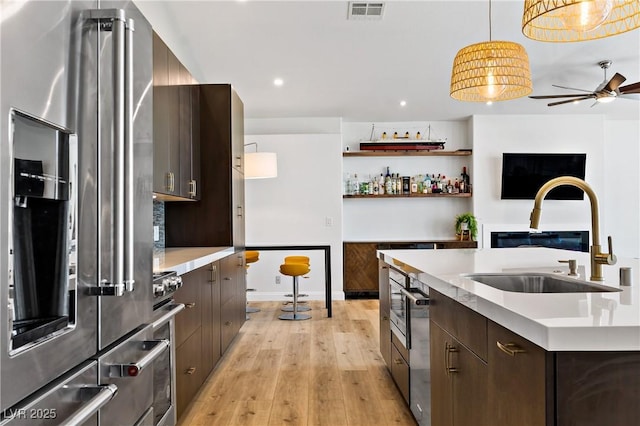 3890 Quadrel St, Las Vegas, NV 89129 - kitchen with stainless steel appliances, light countertops, dark brown cabinetry, and recessed lighting