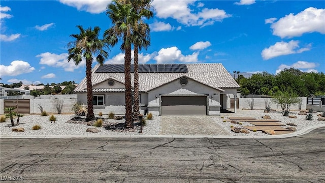 3890 Quadrel St, Las Vegas, NV 89129 - view of front of property featuring stucco siding, a garage, solar panels, decorative driveway, and a gate