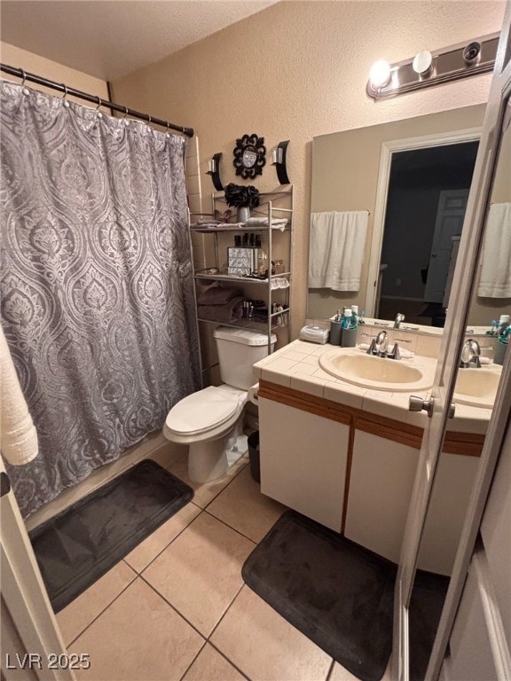 1600 N Torrey Pines Dr Unit 101, Las Vegas, NV 89108 - bathroom featuring vanity, a textured wall, tile patterned floors, and curtained shower