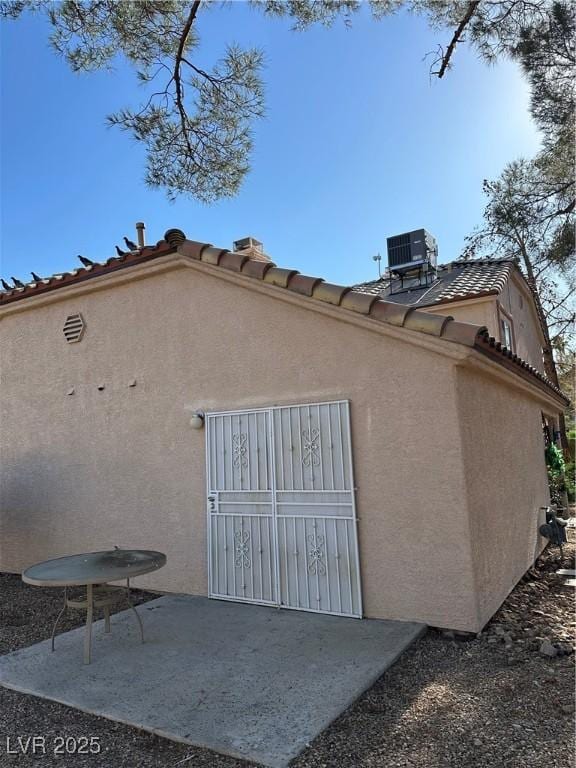 1600 N Torrey Pines Dr Unit 101, Las Vegas, NV 89108 - back of property with a patio, stucco siding, and a tiled roof