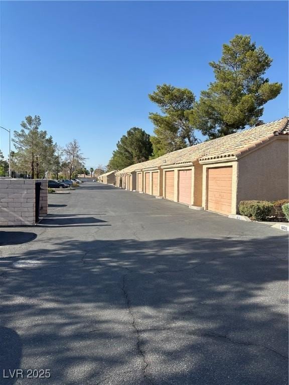 1600 N Torrey Pines Dr Unit 101, Las Vegas, NV 89108 - view of asphalt road with community garages