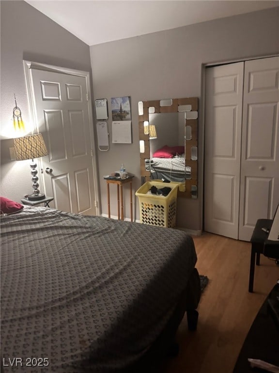 1600 N Torrey Pines Dr Unit 101, Las Vegas, NV 89108 - bedroom featuring light wood-type flooring, a closet, and vaulted ceiling
