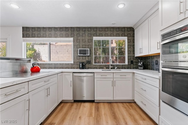 4305 Threshold Ct, North Las Vegas, NV 89032 - kitchen featuring stainless steel appliances, plenty of natural light, tasteful backsplash, light countertops, and recessed lighting