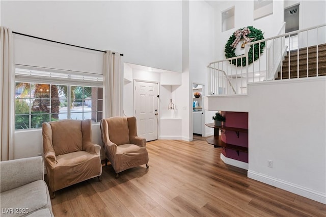 4305 Threshold Ct, North Las Vegas, NV 89032 - living room with a high ceiling, stairway, and wood finished floors