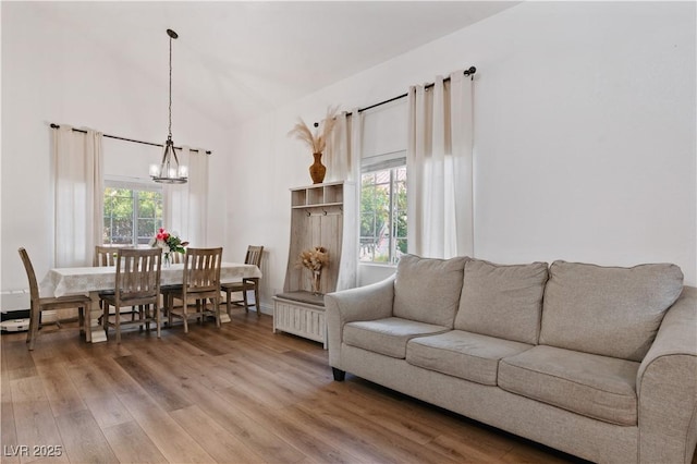 4305 Threshold Ct, North Las Vegas, NV 89032 - living room with a chandelier, light wood-style flooring, and vaulted ceiling