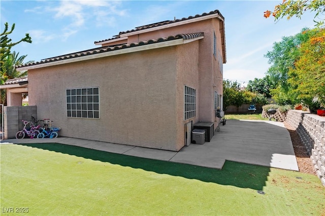 4305 Threshold Ct, North Las Vegas, NV 89032 - view of side of home featuring a patio, stucco siding, and a tile roof