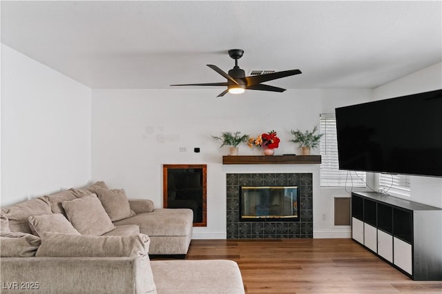 4305 Threshold Ct, North Las Vegas, NV 89032 - living room featuring wood finished floors, ceiling fan, and a fireplace