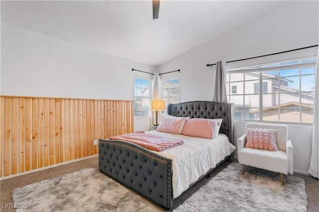 4305 Threshold Ct, North Las Vegas, NV 89032 - carpeted bedroom with wooden walls, a ceiling fan, and wainscoting