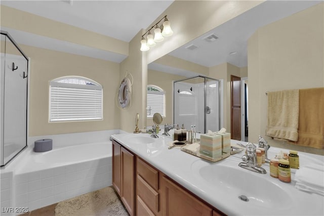 4650 Ranch House Rd Unit 64, North Las Vegas, NV 89031 - full bathroom featuring a shower stall, a garden tub, double vanity, and tile patterned flooring