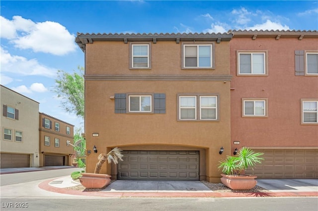 4650 Ranch House Rd Unit 64, North Las Vegas, NV 89031 - view of front facade with an attached garage and stucco siding