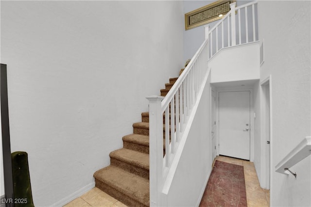 4650 Ranch House Rd Unit 64, North Las Vegas, NV 89031 - stairs with tile patterned floors and a towering ceiling