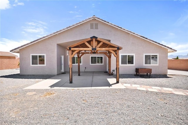 5210 E Chasemoor St, Pahrump, NV 89061 - rear view of property featuring stucco siding, a fenced backyard, and a patio area