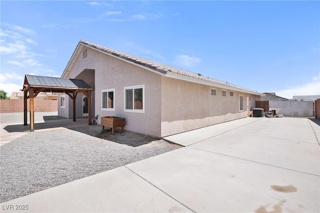 5210 E Chasemoor St, Pahrump, NV 89061 - rear view of property with stucco siding, a patio area, and a gazebo