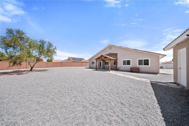 5210 E Chasemoor St, Pahrump, NV 89061 - back of house with a fenced backyard, a patio, and stucco siding
