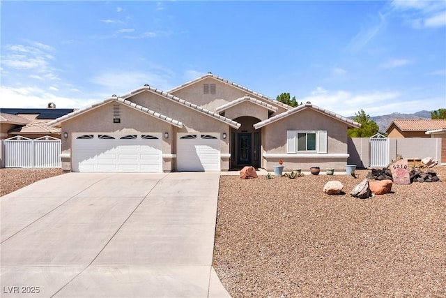 5210 E Chasemoor St, Pahrump, NV 89061 - view of front of house with a gate, an attached garage, driveway, and stucco siding