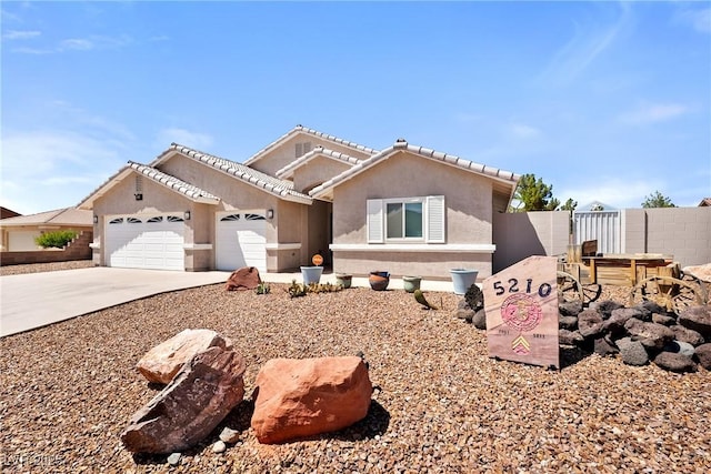 5210 E Chasemoor St, Pahrump, NV 89061 - view of front of property with driveway, an attached garage, stucco siding, and a tiled roof