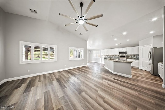 5210 E Chasemoor St, Pahrump, NV 89061 - unfurnished living room featuring recessed lighting, wood finished floors, a ceiling fan, and high vaulted ceiling