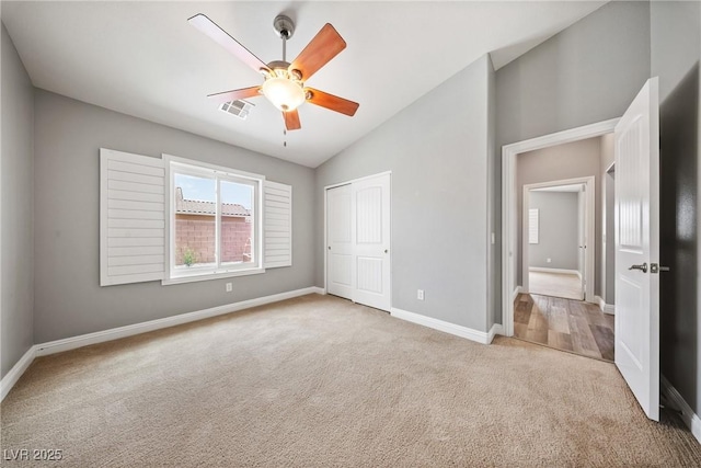 5210 E Chasemoor St, Pahrump, NV 89061 - unfurnished bedroom featuring carpet floors, lofted ceiling, a closet, and a ceiling fan