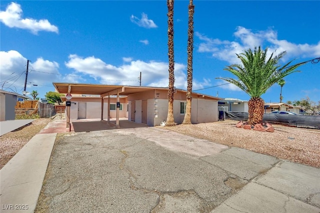 1205 Phillips Ave, Las Vegas, NV 89104 - view of front of home with driveway, an attached carport, and stucco siding
