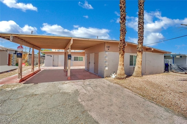 1205 Phillips Ave, Las Vegas, NV 89104 - view of front of home featuring a storage shed, an attached carport, concrete block siding, and driveway