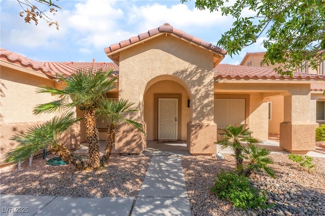 1442 Big Tree Ave, North Las Vegas, NV 89031 - doorway to property featuring a tiled roof and stucco siding