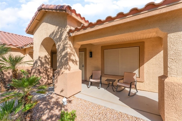 1442 Big Tree Ave, North Las Vegas, NV 89031 - property entrance featuring a tiled roof and stucco siding