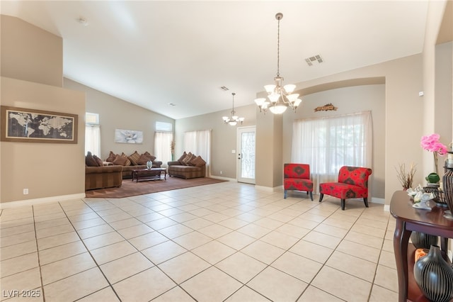 1442 Big Tree Ave, North Las Vegas, NV 89031 - living room featuring a chandelier, vaulted ceiling, healthy amount of natural light, and light tile patterned flooring