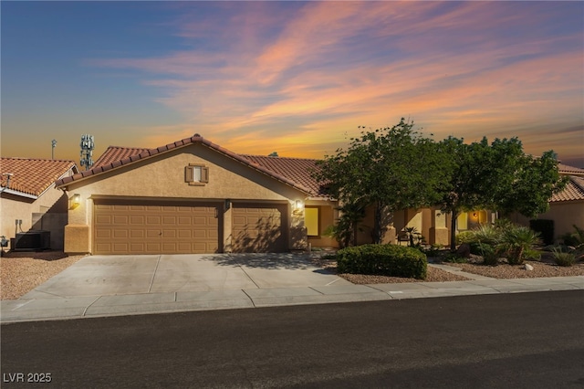 1442 Big Tree Ave, North Las Vegas, NV 89031 - mediterranean / spanish house with stucco siding, a garage, a tile roof, and concrete driveway