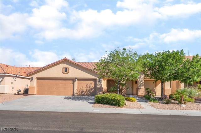 1442 Big Tree Ave, North Las Vegas, NV 89031 - view of front facade with stucco siding, an attached garage, concrete driveway, and a tile roof
