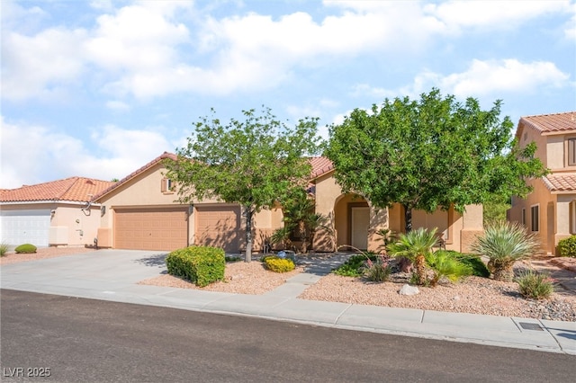1442 Big Tree Ave, North Las Vegas, NV 89031 - view of front of house featuring a tile roof, stucco siding, driveway, and an attached garage