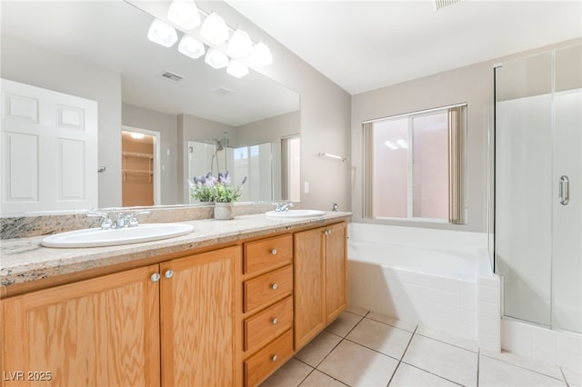 1442 Big Tree Ave, North Las Vegas, NV 89031 - full bathroom with double vanity, a stall shower, tile patterned flooring, and a garden tub