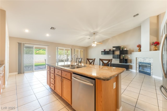 1442 Big Tree Ave, North Las Vegas, NV 89031 - kitchen with dishwasher, light tile patterned flooring, an island with sink, light stone counters, and vaulted ceiling
