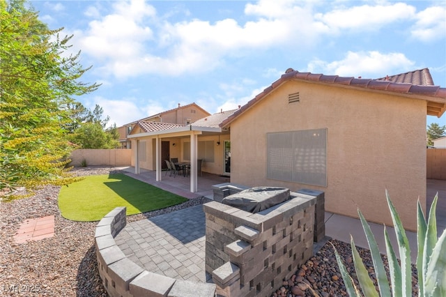 1442 Big Tree Ave, North Las Vegas, NV 89031 - rear view of property featuring stucco siding, a fenced backyard, a patio, and a tiled roof