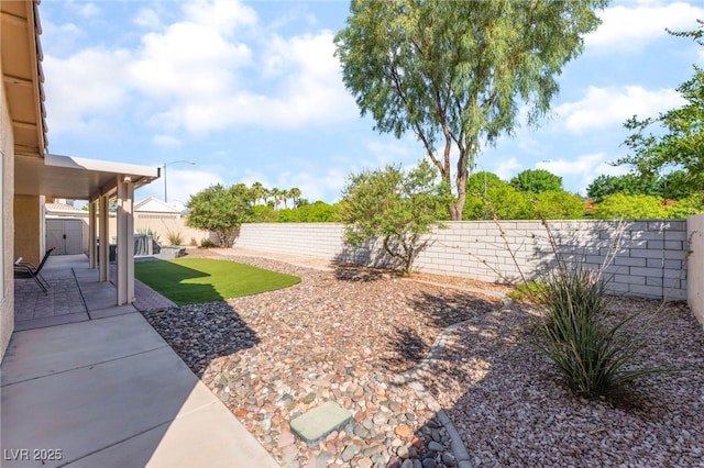 1442 Big Tree Ave, North Las Vegas, NV 89031 - fenced backyard with a patio area