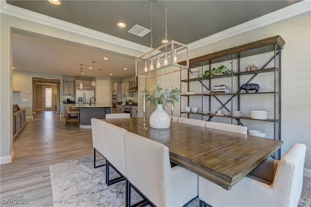 9964 Peaceful Peaks Ave, Las Vegas, NV 89166 - dining room with ornamental molding, recessed lighting, and light wood finished floors