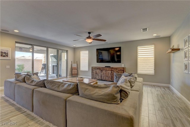 9964 Peaceful Peaks Ave, Las Vegas, NV 89166 - living room featuring light wood finished floors, ceiling fan, healthy amount of natural light, and recessed lighting