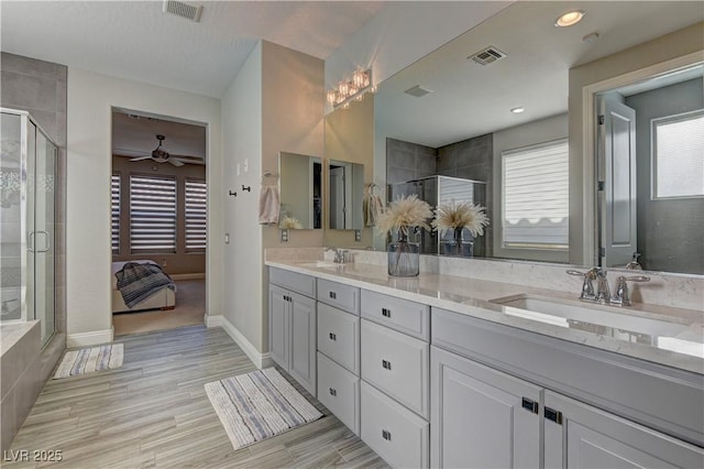 9964 Peaceful Peaks Ave, Las Vegas, NV 89166 - full bath with double vanity, a stall shower, ceiling fan, and wood finished floors
